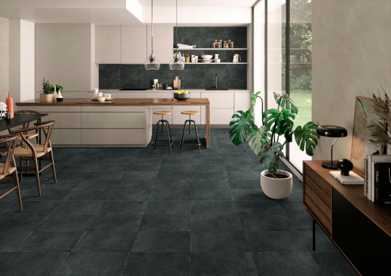 Charcoal full-body porcelain tiles on a modern kitchen floor.