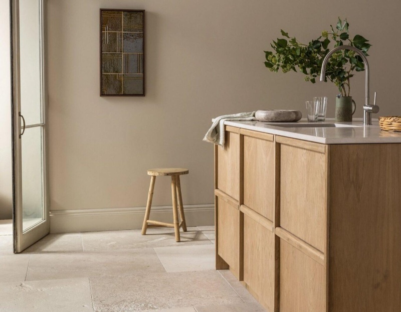 Pale natural limestone floor tiles in a minimalist kitchen.
