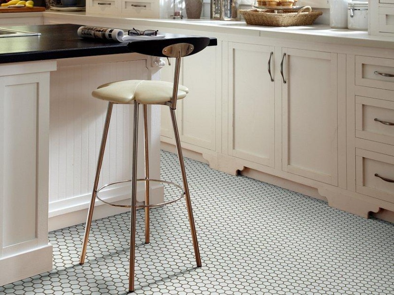 Grey and white hexagonal mosaic tiles on a kitchen floor.