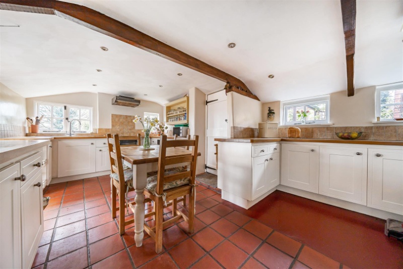Traditional red-brown quarry floor tiles in a country kitchen.